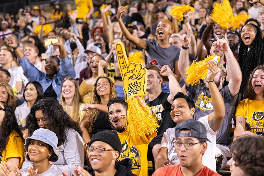 large group of students in the bleachers supporting the team.